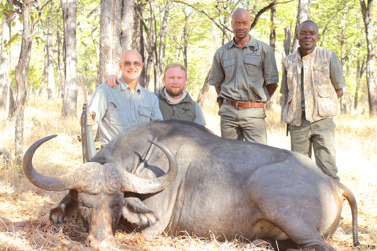 Author and buffalo with guide and trackers